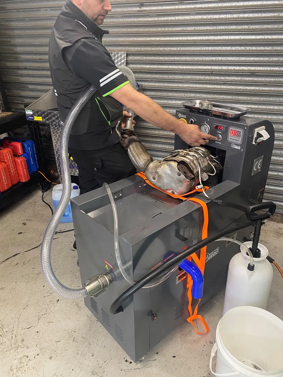 Removed diesel particulate filter secured to the workshop cleaning machine
